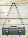 Horace and Jasper leather kitchen knife roll in brown with shoulder strap. Photographed at Crossroads Market in Calgary.