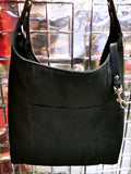 Heavy canvas tote bag with large exterior pocket and leather tether for keys.