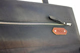 Large zippered pocket from interior of made in Calgary knife roll. Leather patch with Horace and Jasper logo detail.